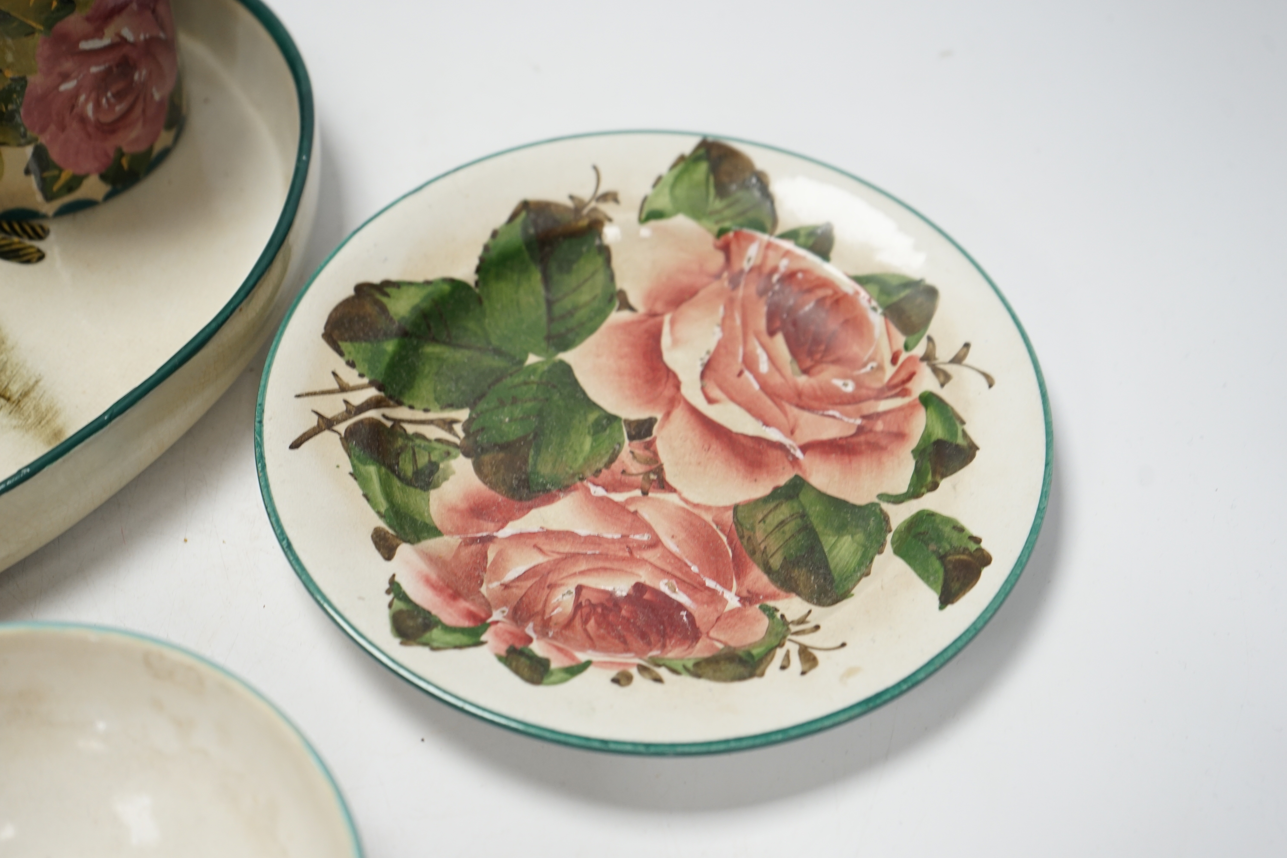 Wemyss ware - a roses preserve jar, three other items and an unusual ‘hair tongs’ heart shaped dish, largest 30cm